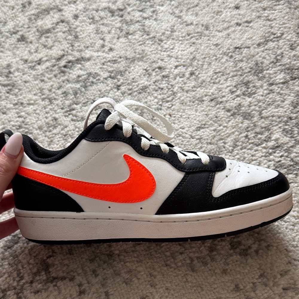 Nike Black and White Shoes with Vibrant Orange Logo